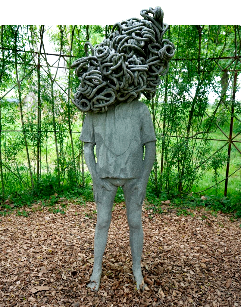 Work by Paolo Grassino depicting a person with a tangled head, because instead of a head, this person has pipes all mixed up.